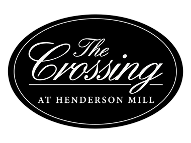Logo for The Crossing at Henderson Mill in light gray inside an oval outline