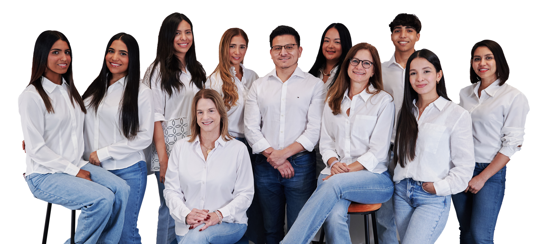 A group of people in white shirts and blue jeans are posing for a picture.