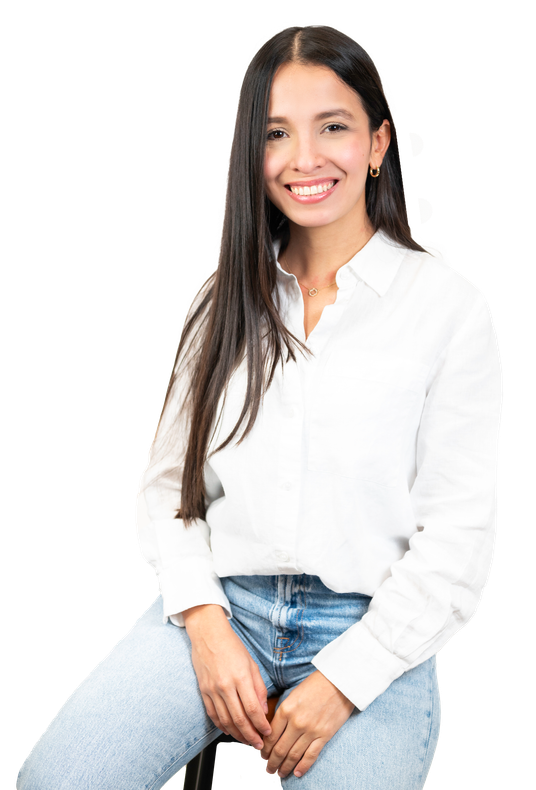 A woman is sitting on a stool wearing a white shirt and jeans.