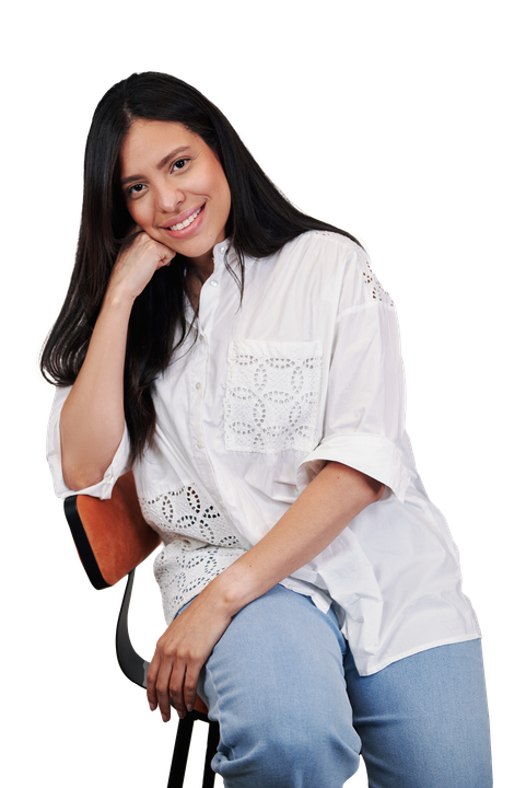 A woman in a white shirt and blue jeans is sitting on a chair.