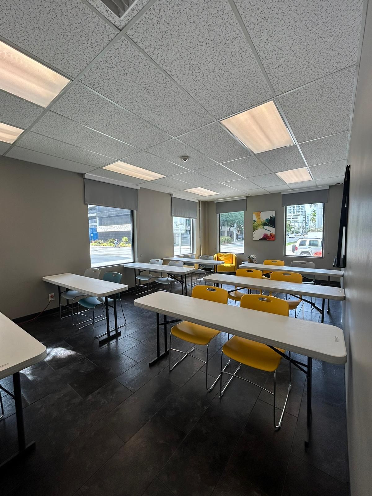 A large room with tables and chairs in it.