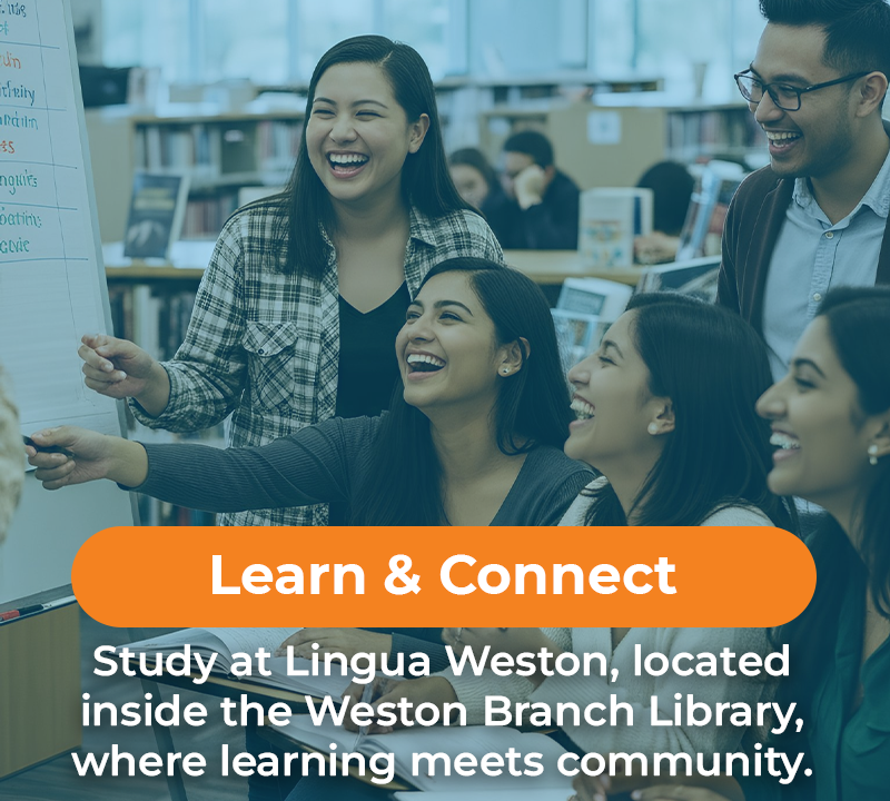 Group of smiling students studying in a library.