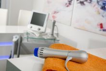 A microphone is sitting on top of an orange towel on a table.