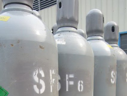 Une rangée de bouteilles de gaz est alignée devant un immeuble.