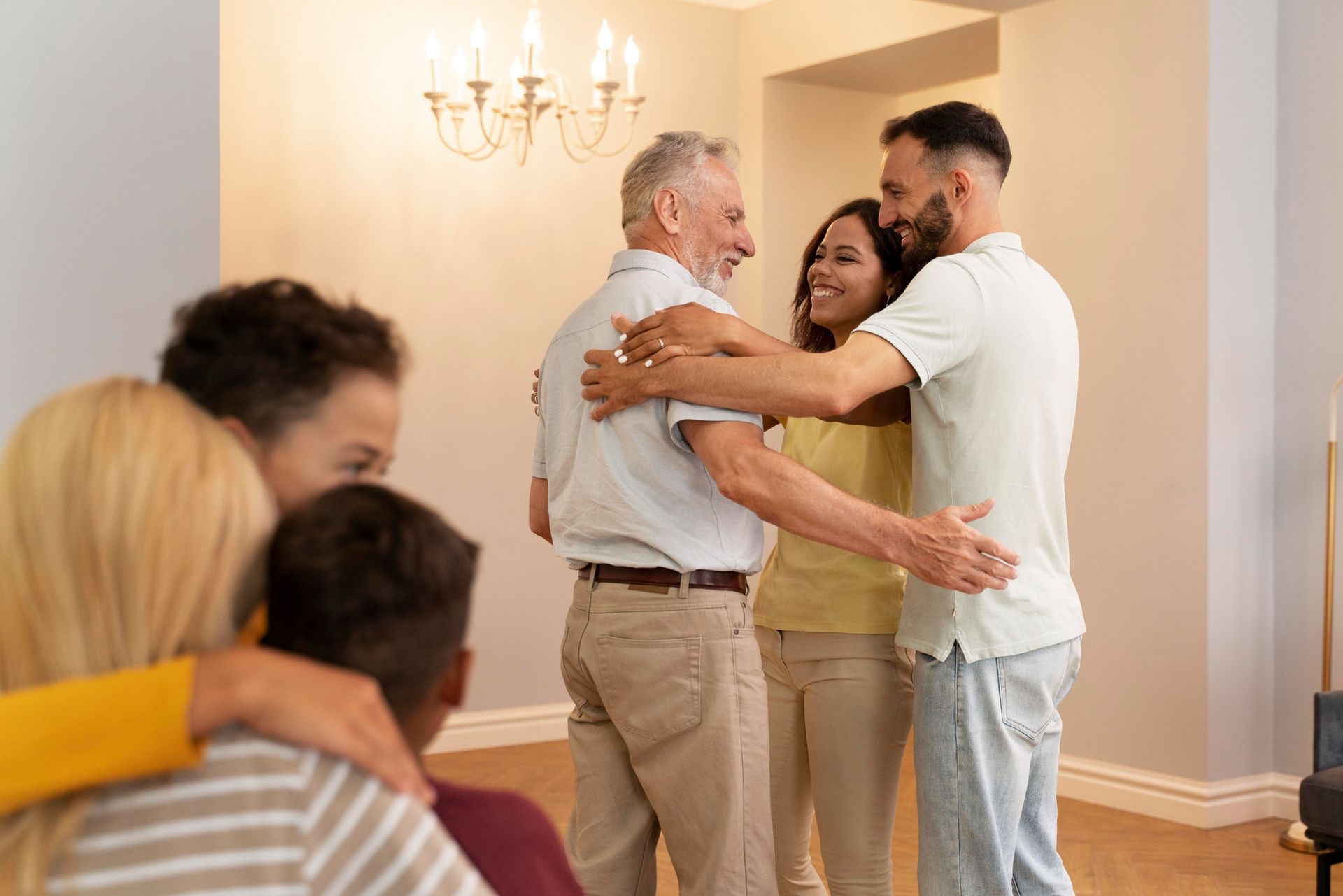 Family members embracing indoors; warm smiles and joy.