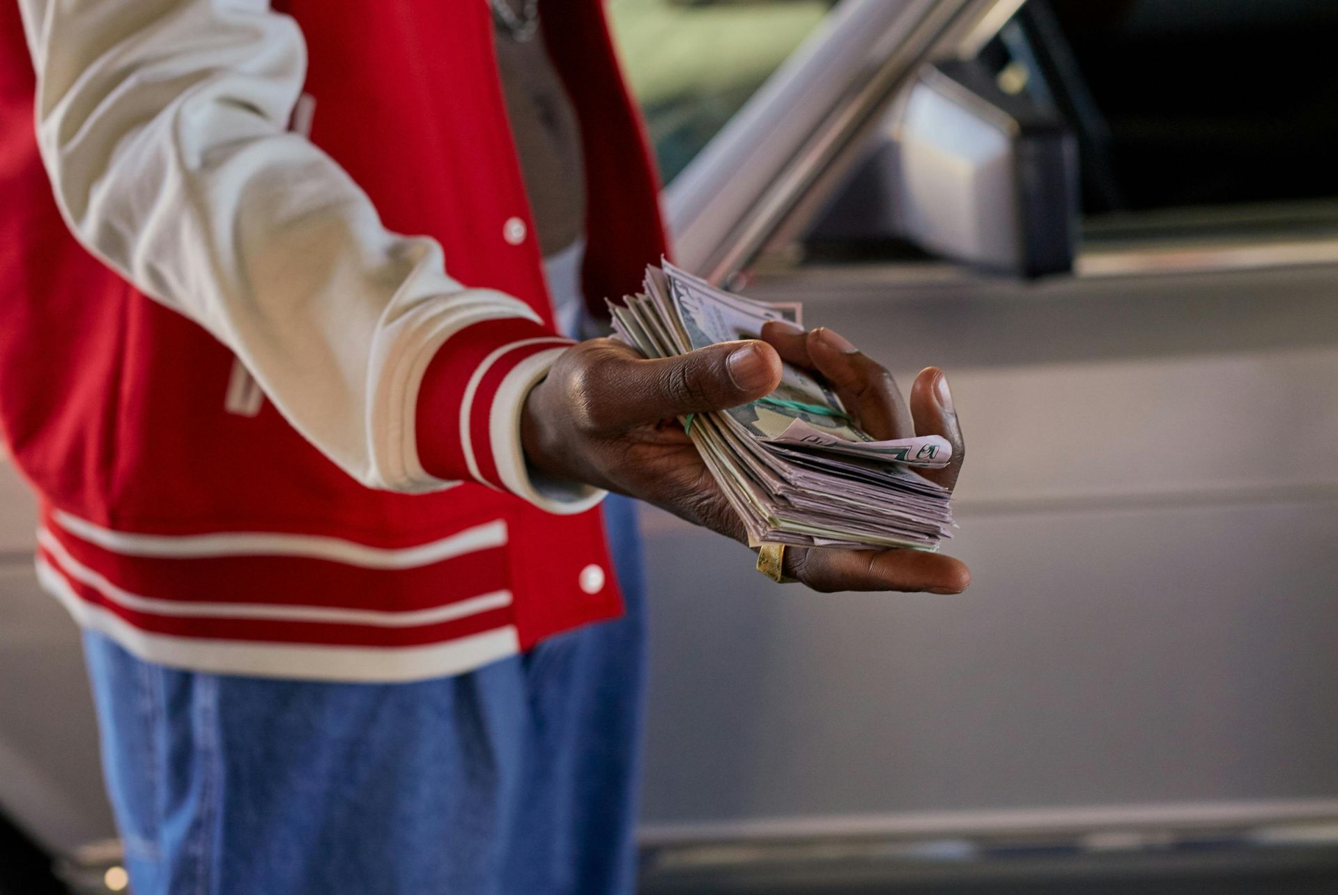 Person holding a wad of cash for a cash offer. 