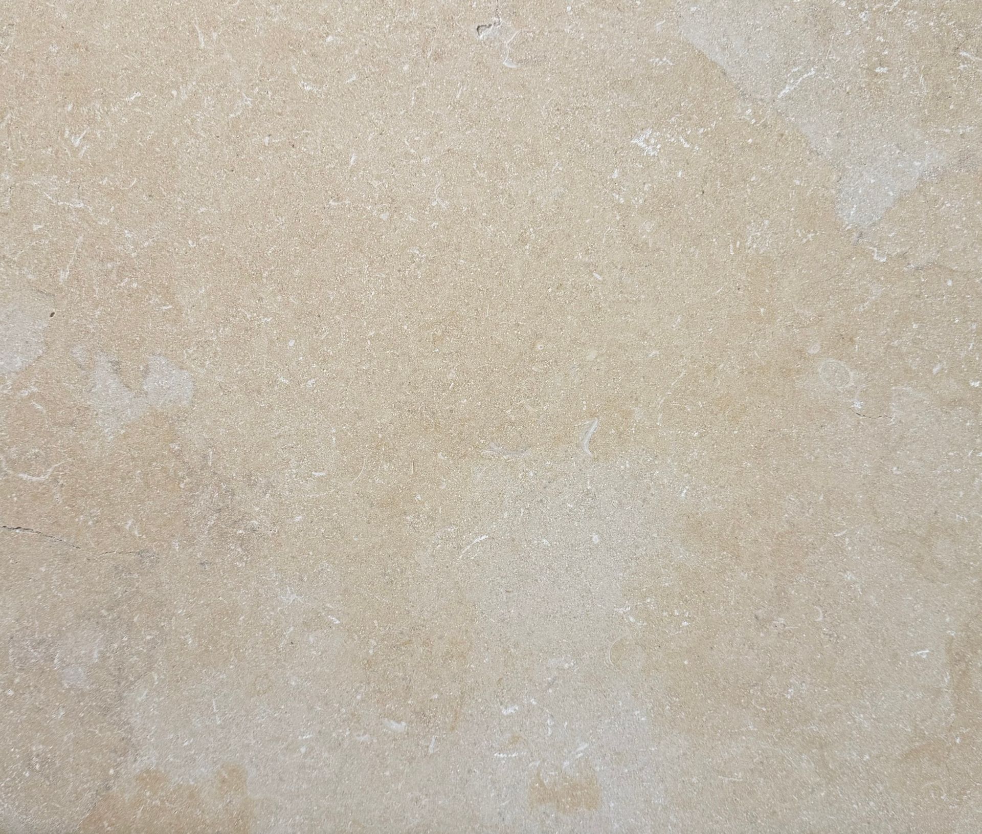 Gray stone texture with subtle variations and a diagonal line.