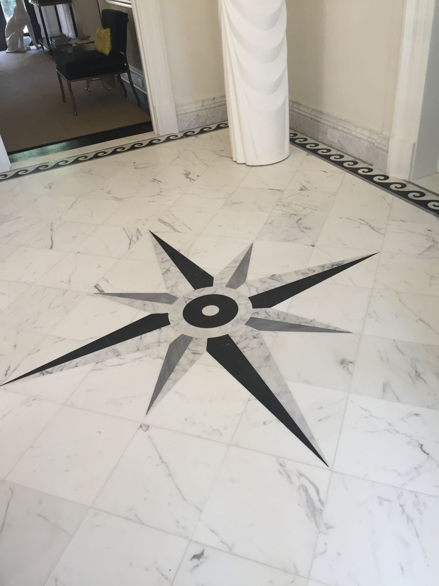 Marble floor with compass rose design, black, gray, and white.