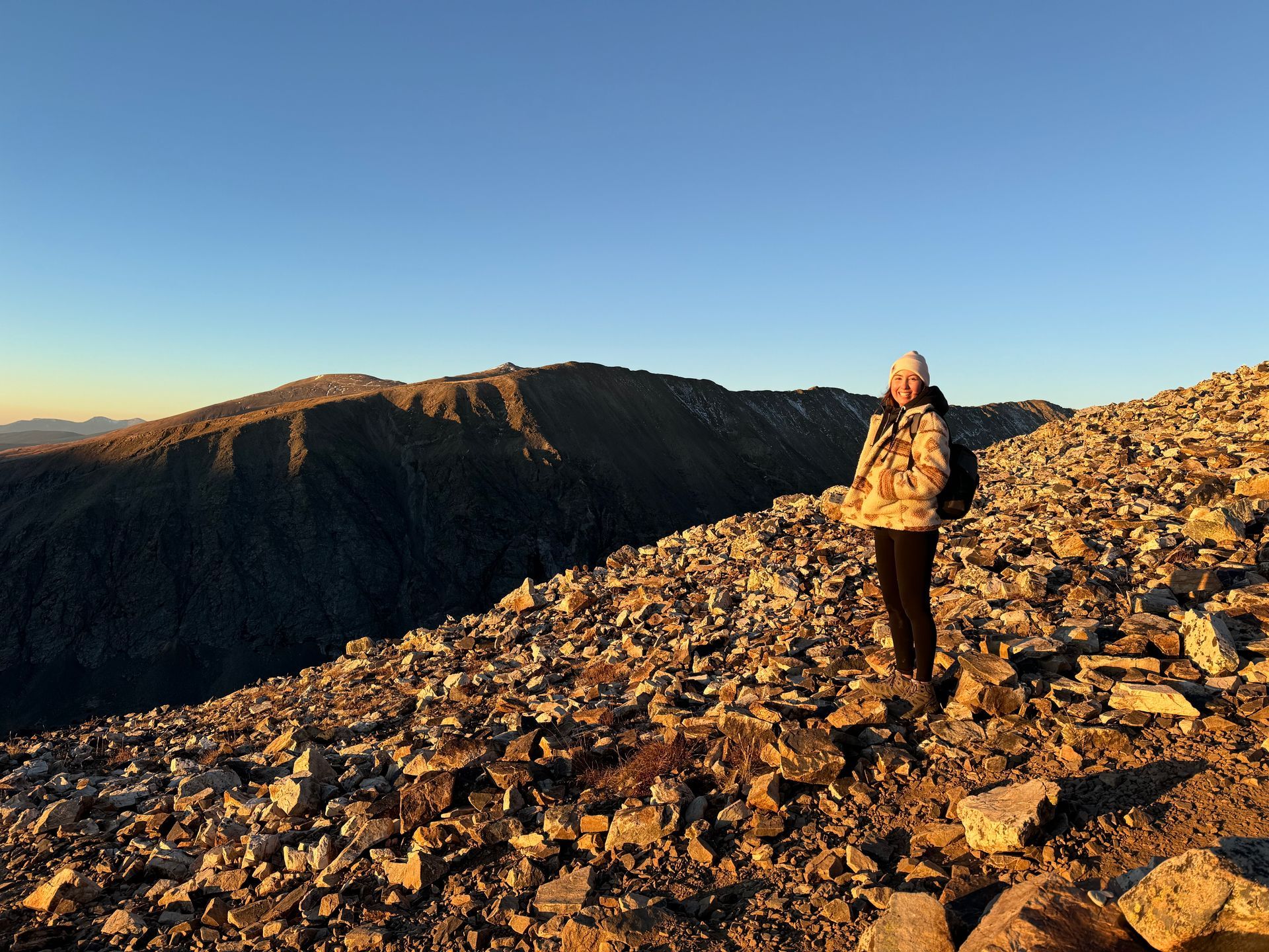 a girl standing on a rock mountain