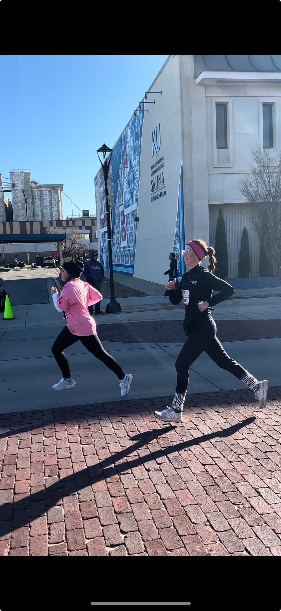 two girls running in a marathon