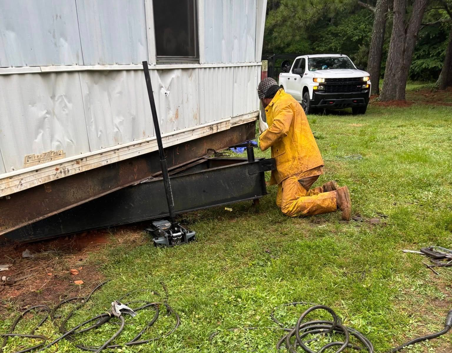 Steel framework of a building under construction, with beams, girders, and columns against a cloudy sky.