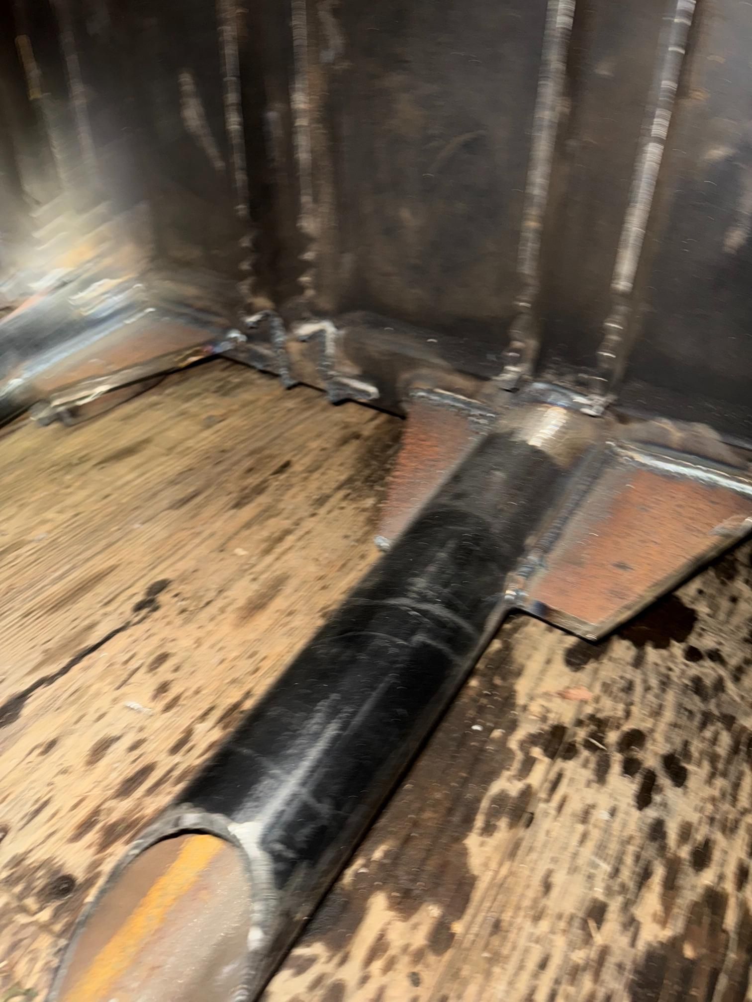 Welded metal structure corner with a tube support.