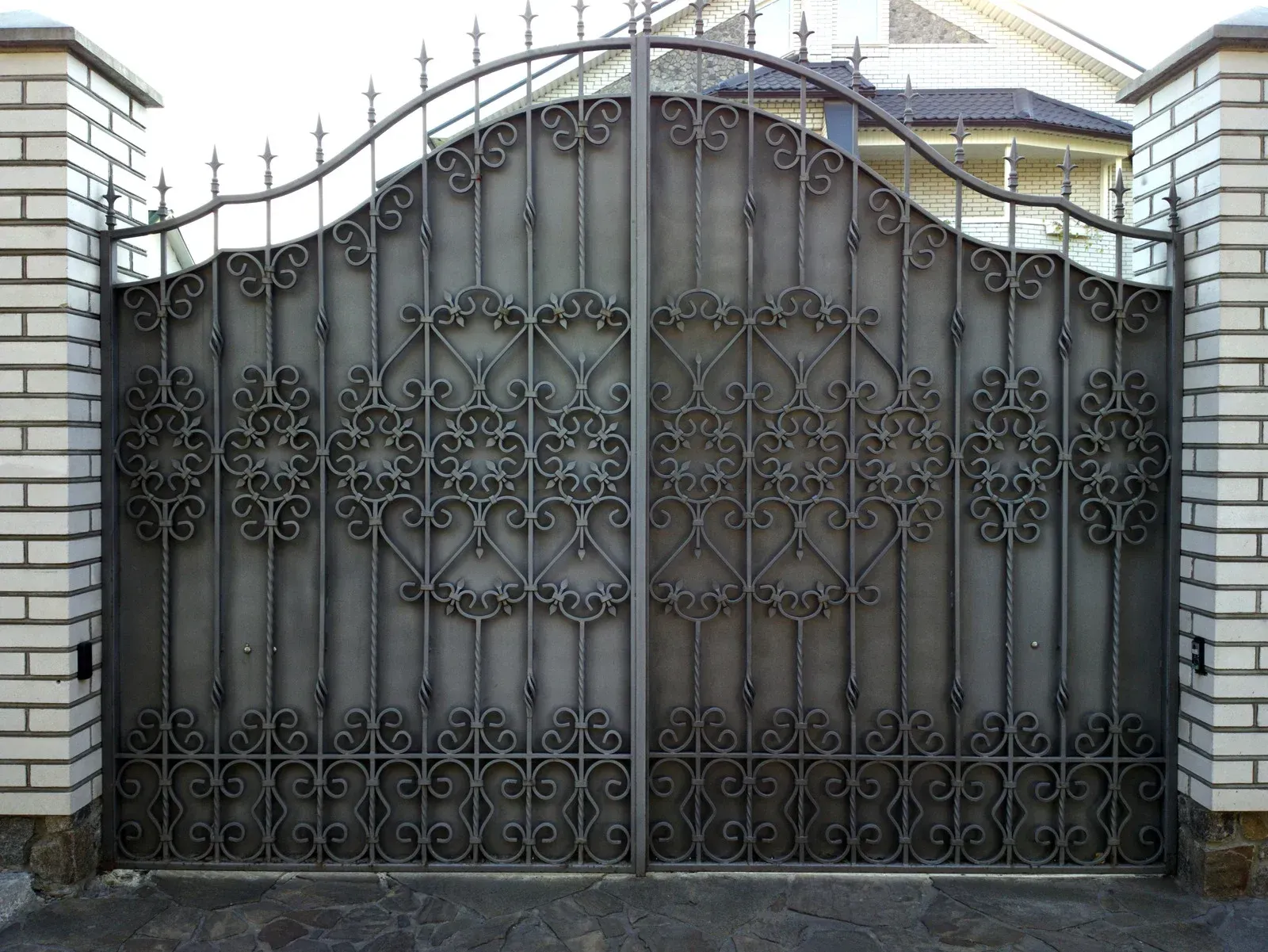 Wooden staircase with a metal railing and glass panels in a modern building.