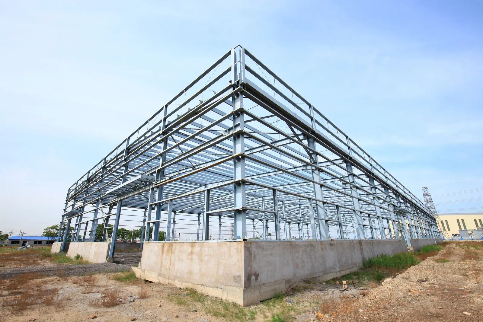 White steel roof trusses and panels inside a building.