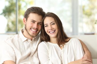 Picture of a smiling couple sitting down