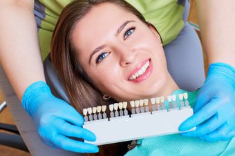 Woman selecting dental implants at dentist's office