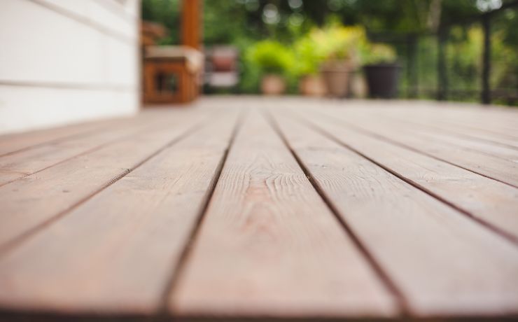 A photo of a deck that is beautifully built. The attention to detail is shown from the angle of the photo. In this view you can see how perfectly level the deck is.