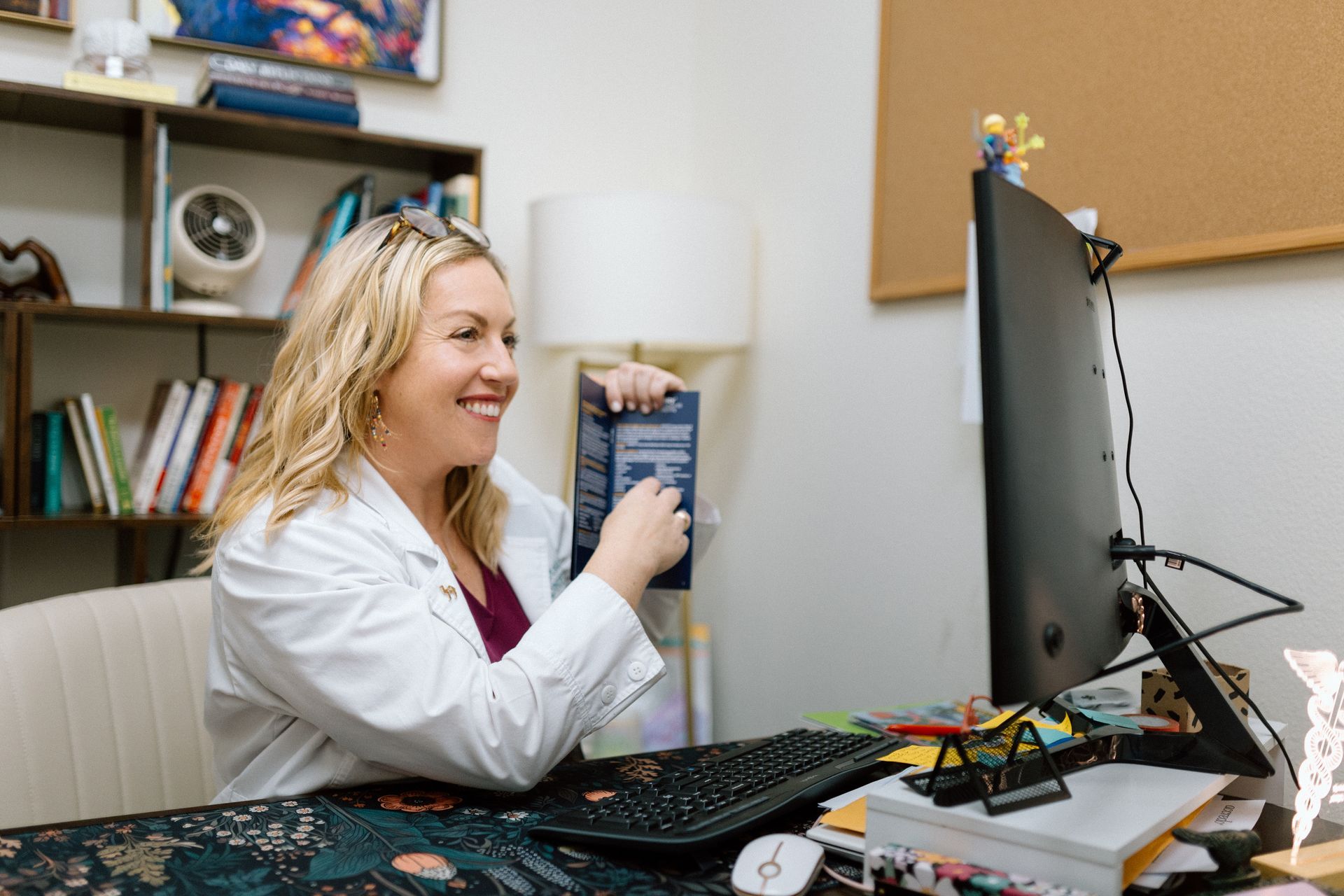 A man and a woman are sitting in chairs talking to each other.