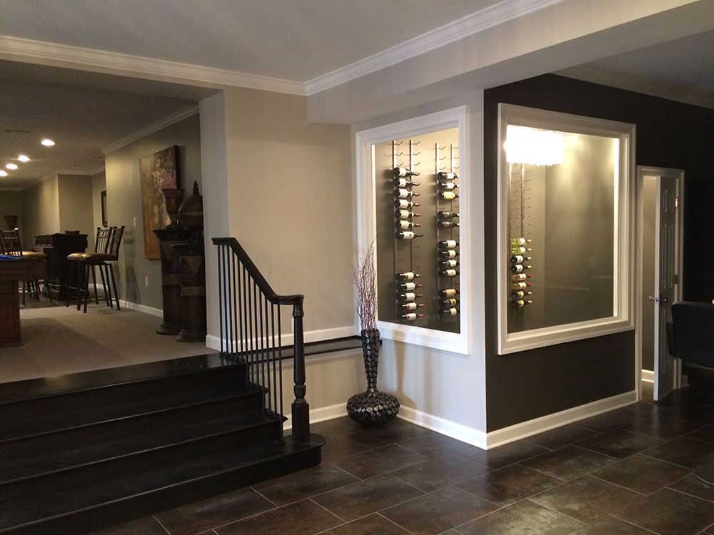 A large room with stairs leading up to a wine cellar.