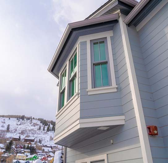 A house with a balcony and the number 13 on the side