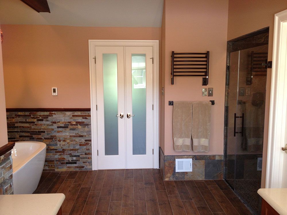 A bathroom with a bathtub and a towel rack
