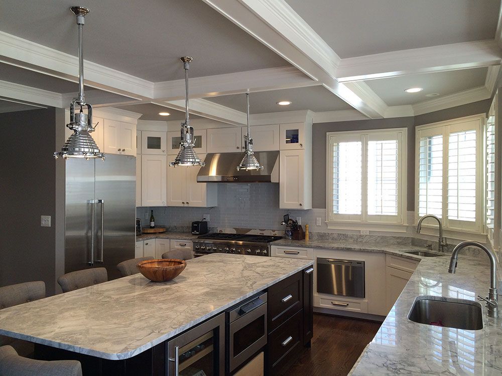 A kitchen with a large island and stainless steel appliances