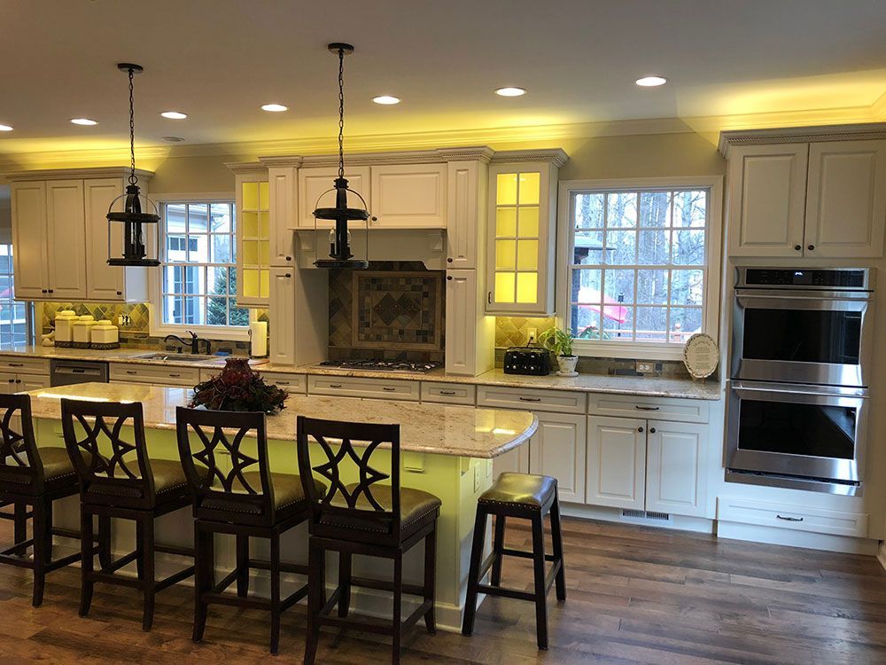 A large kitchen with white cabinets and stainless steel appliances.