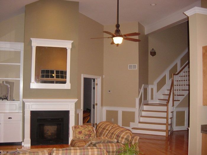 A living room with a fireplace and stairs