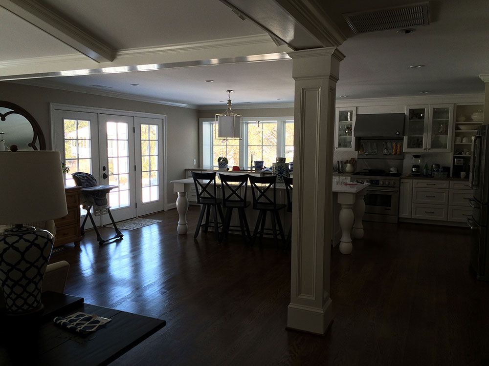 A living room with a table and chairs in it