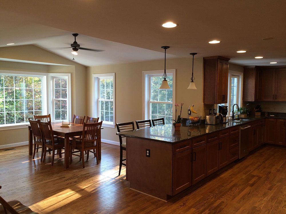 A kitchen with a dining table and chairs and a large island.