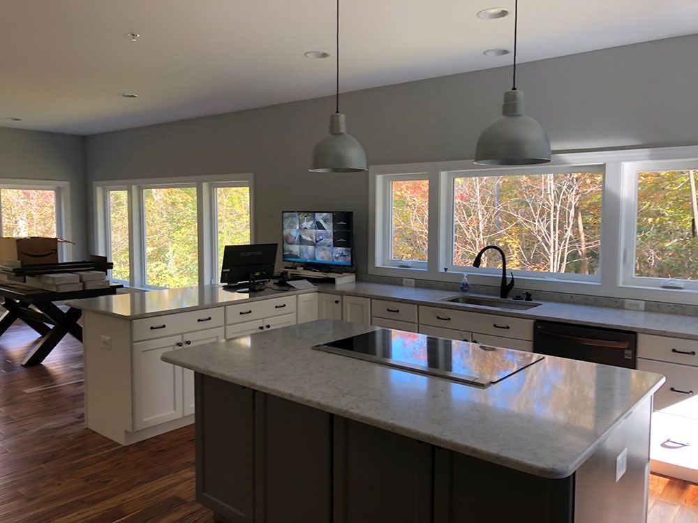A kitchen with a large island in the middle and a lot of windows.