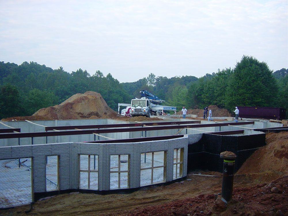 A construction site with a large pile of dirt in the background