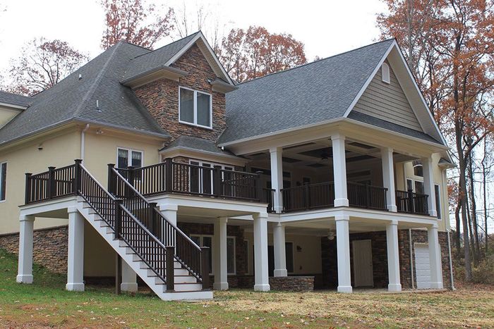 A large house with a large deck and stairs