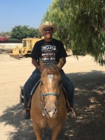 A man in a cowboy hat is riding a horse.