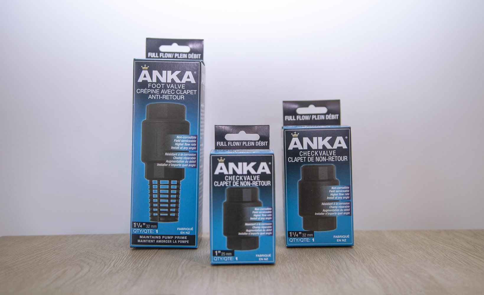Three Anka water filter packages of varying sizes, black and blue, on a surface.