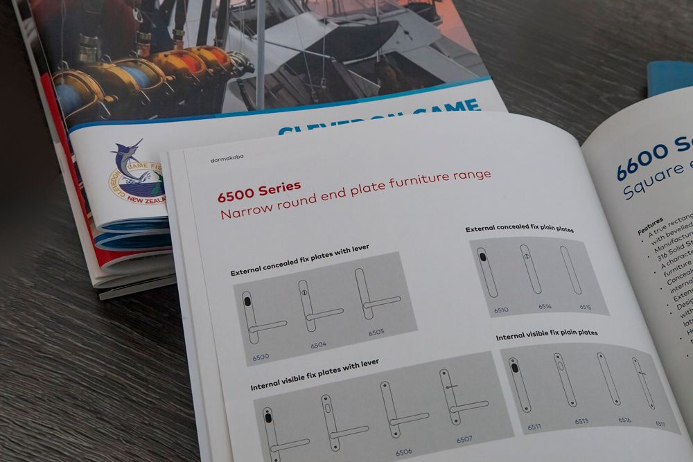 Open book with diagrams, next to another book. Close-up shot of a text page and cover.