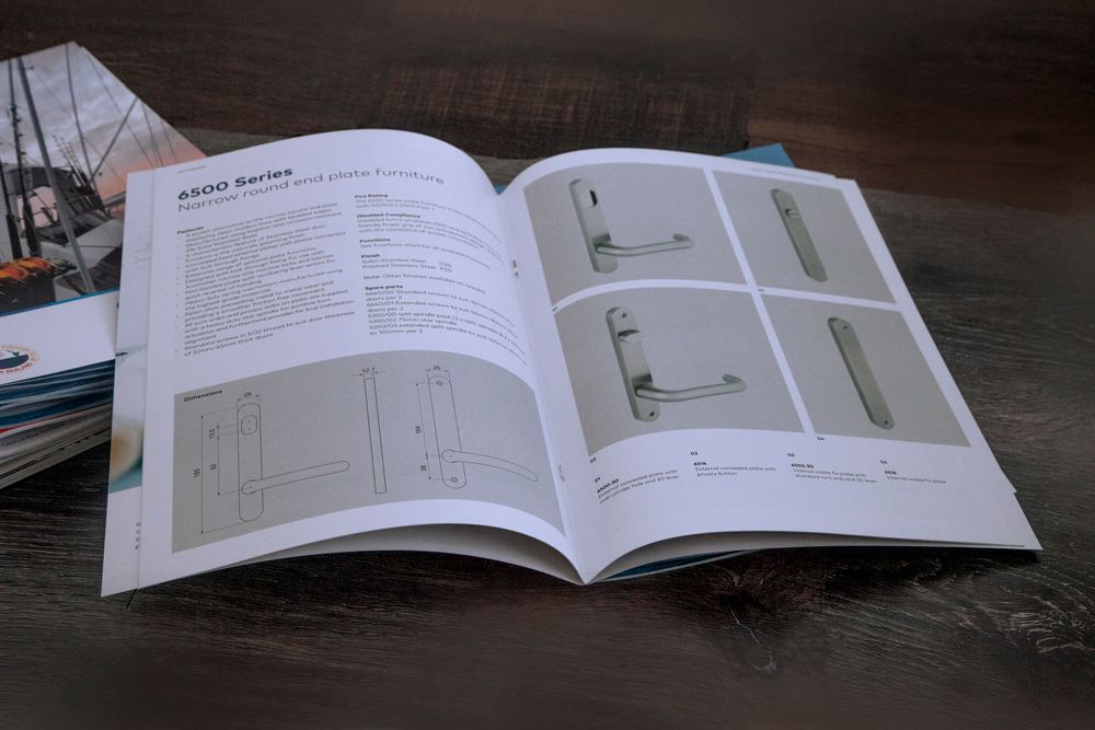 Open book with diagrams and product images on a wooden table.