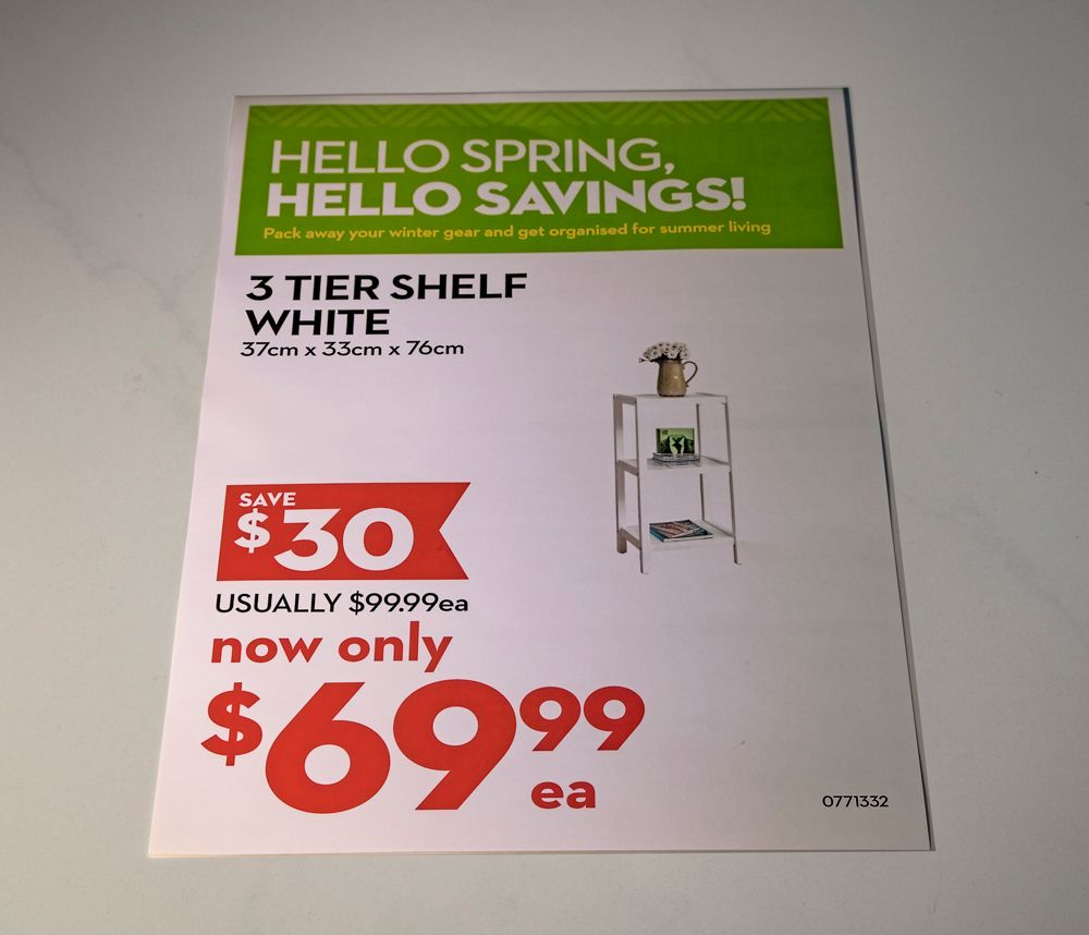Advertisement for a white 3-tier shelf, on sale for $69.99. Green, white, and red colors.