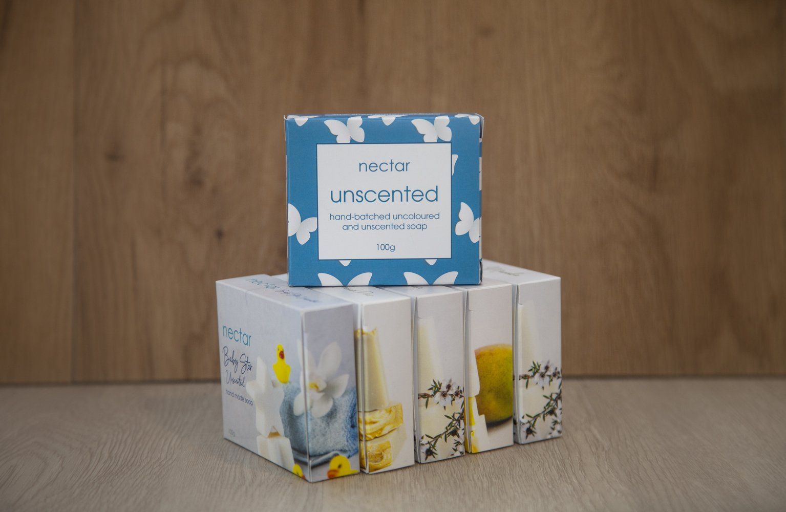 Stacked boxes of Vector Unscented soap, blue box on top with butterfly design.