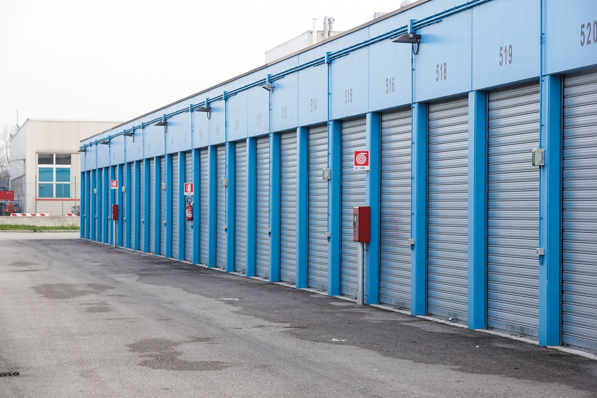 The interior of a modern storage facility with metal doors and locks.
