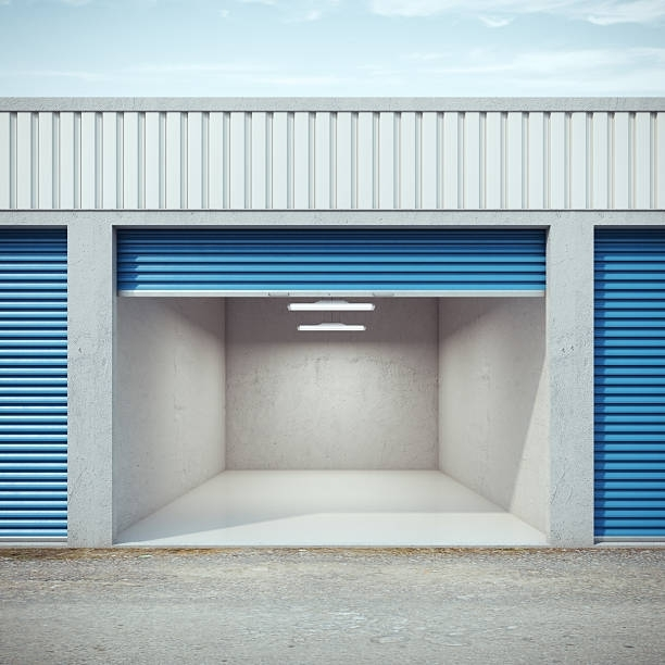 Empty storage unit with lights on and a light blue door.