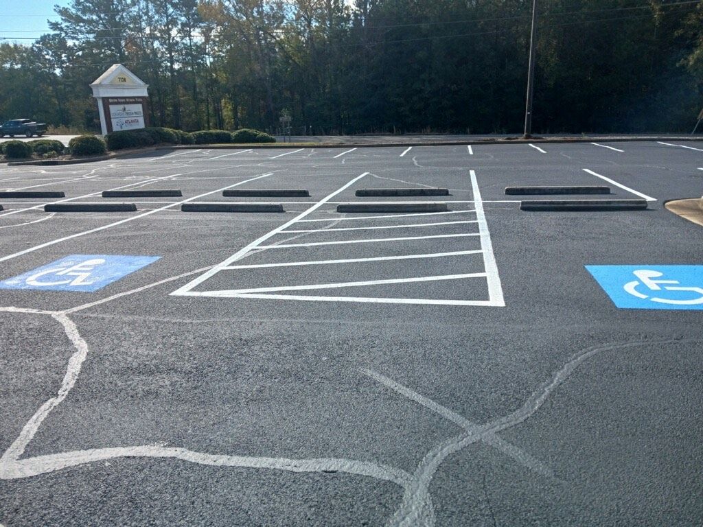 Parking lot with a handicap parking spot and access aisle.