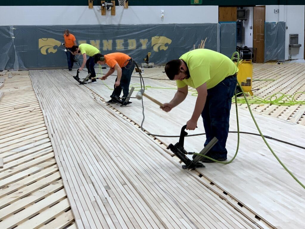 Men Installing Wood Flooring — New London, WI — Stalker Sports Floors