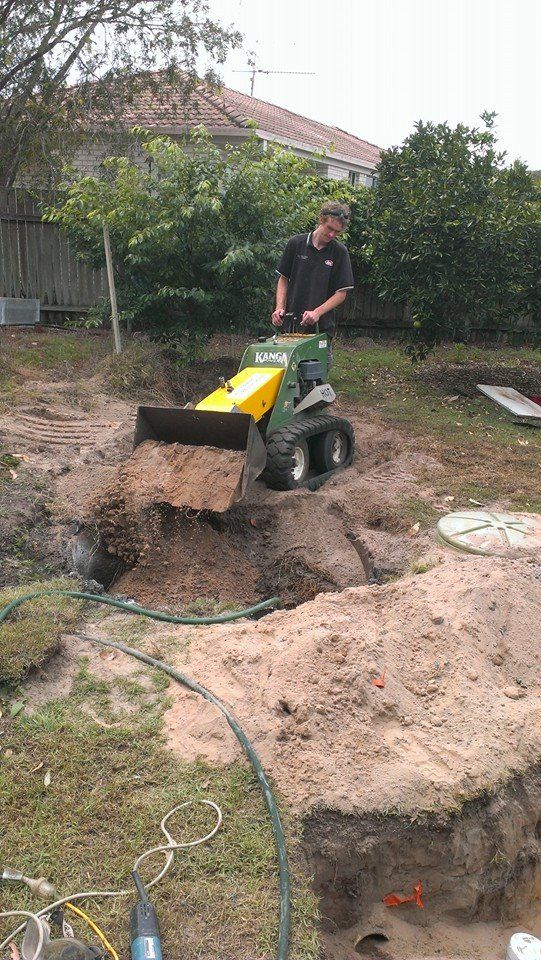 Digging With Mini Excavator To Fix Sewerage Issue — Plumbing In Ashby, NSW