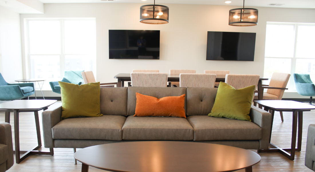 Sky Lounge with modern furniture, two TVs, and multiple seating areas.