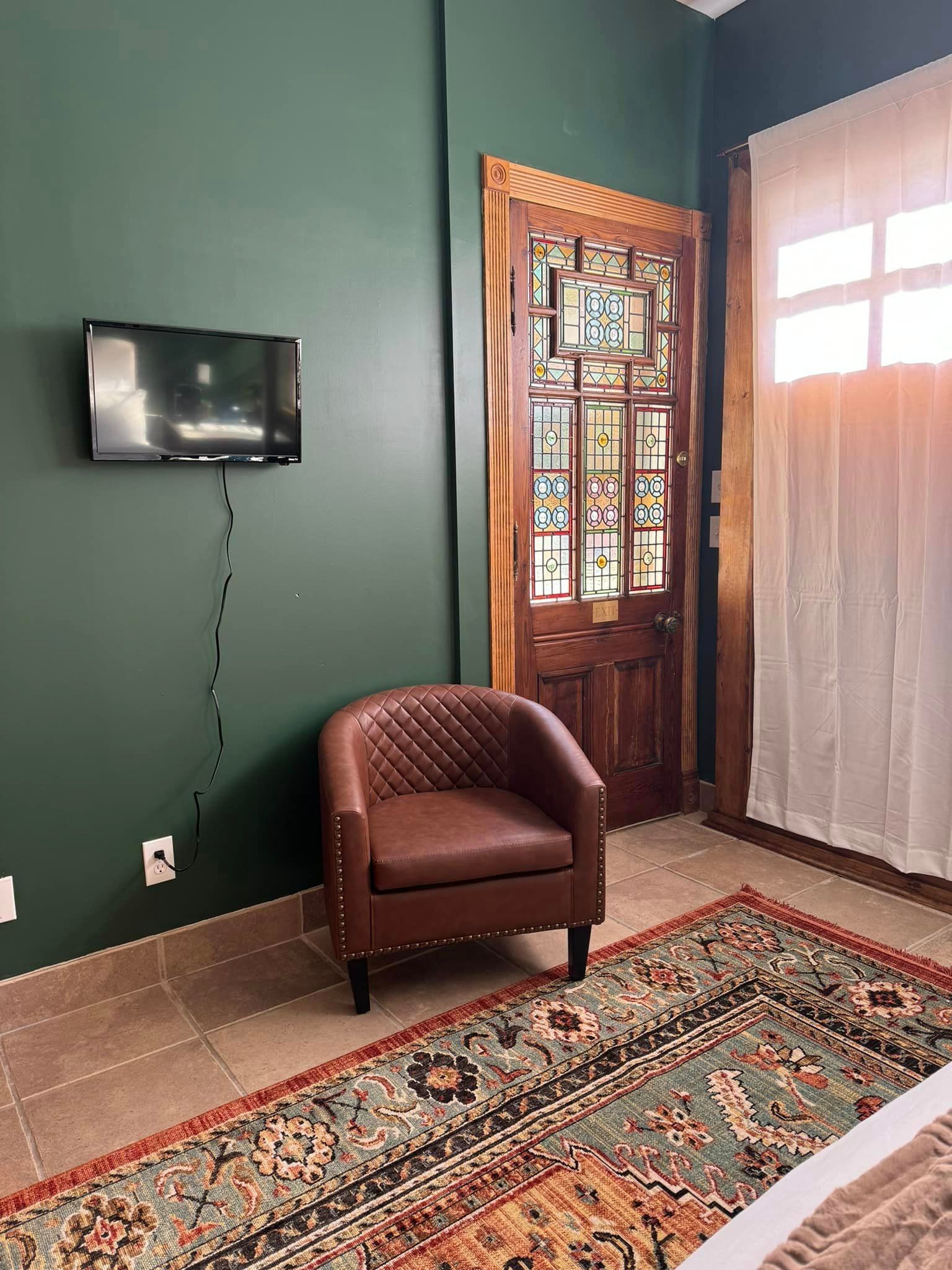 There is a chair and a television in the room.