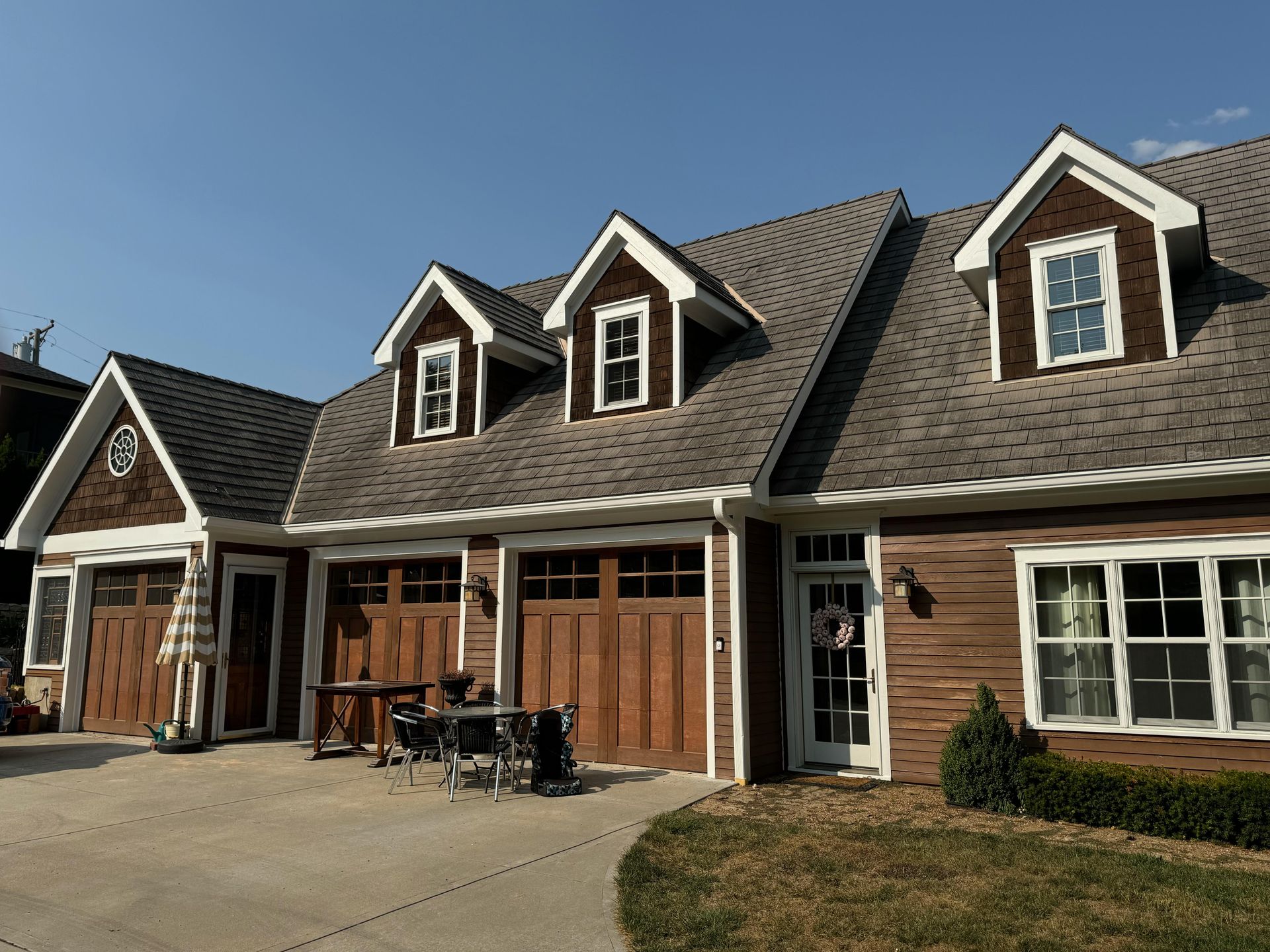 A large house with a lot of windows and garage doors
