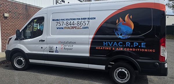 HVAC.R.P.E. van with logo, phone number, and website on the side. Heating and air conditioning service vehicle.