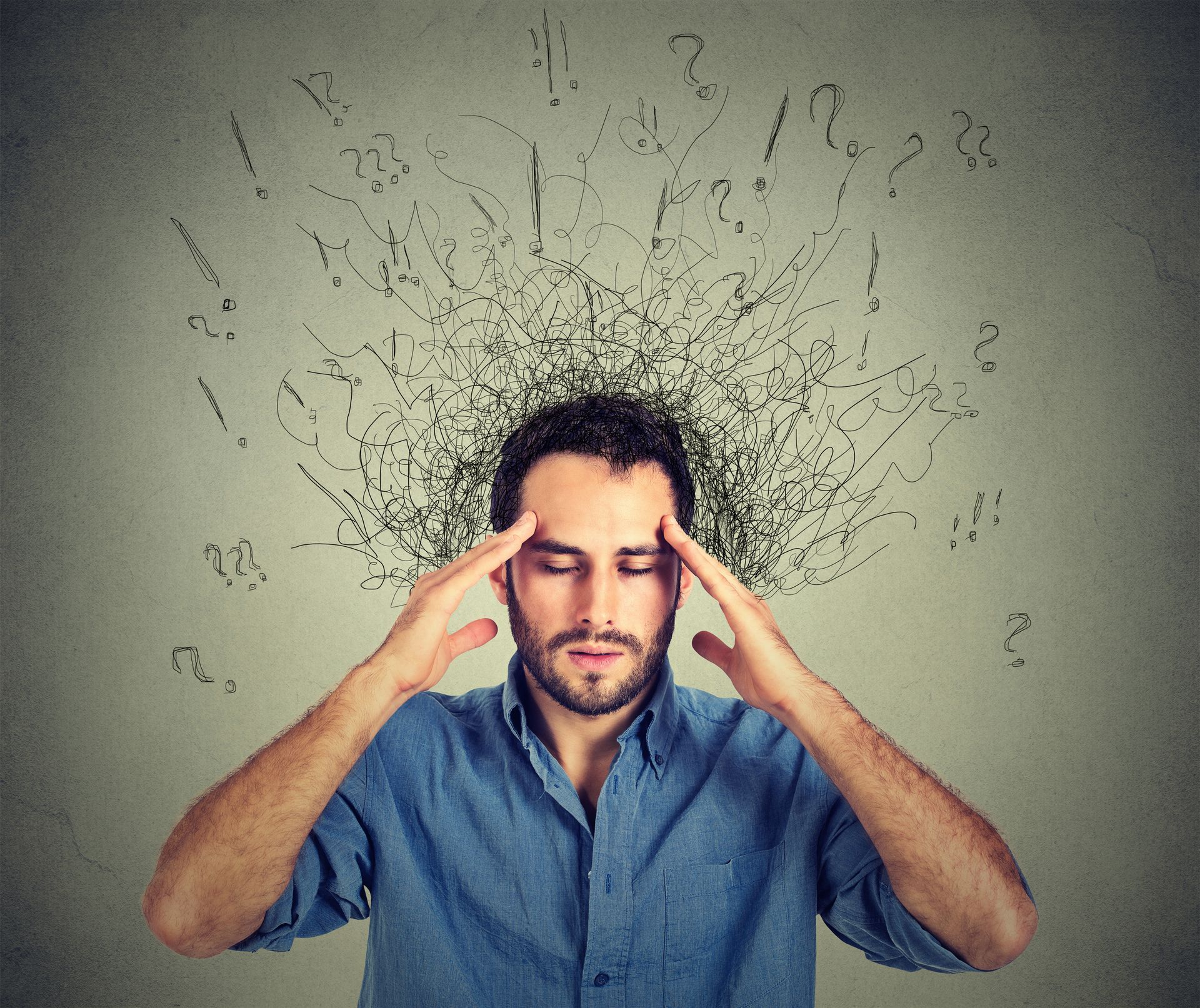 Man with closed eyes, hands on temples, surrounded by scribbled lines, possibly indicating stress or anxiety.