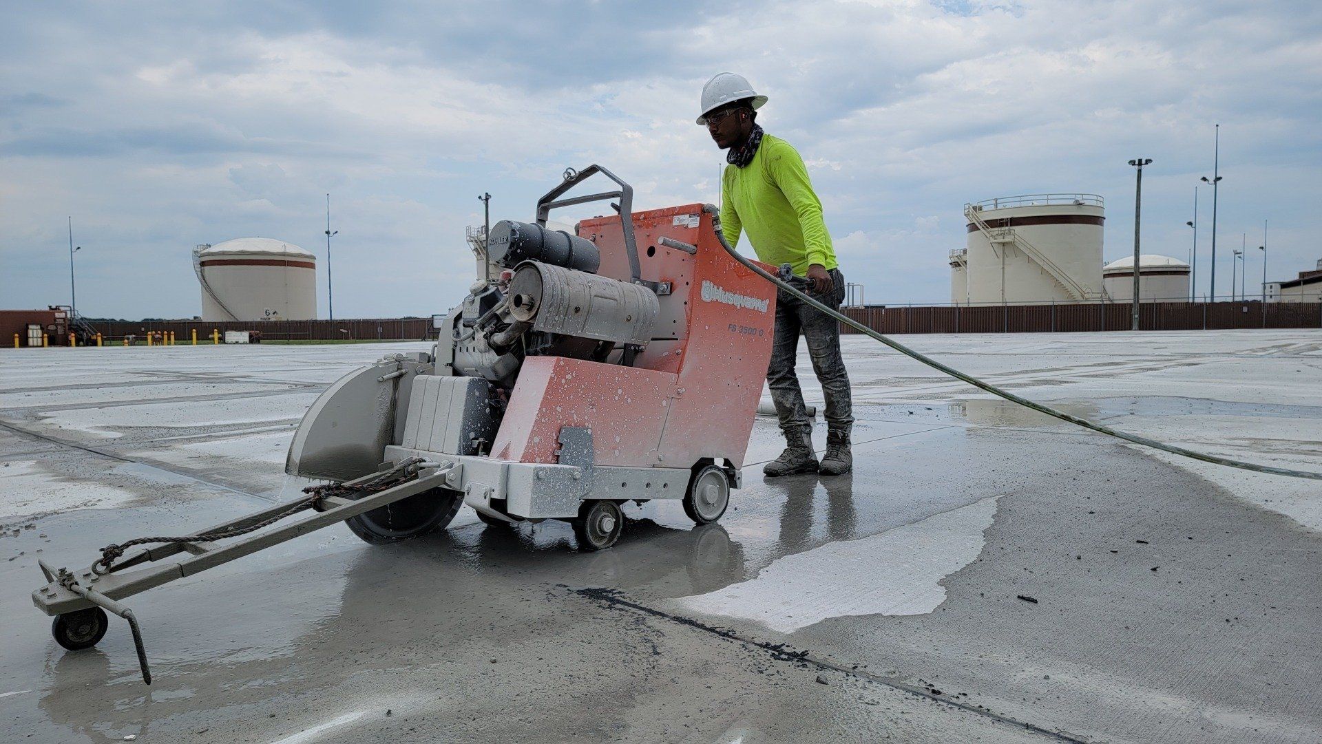 a man is using a machine to cut concrete
